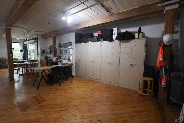 interior space featuring wood ceiling, beamed ceiling, hardwood / wood-style flooring, and a barn door