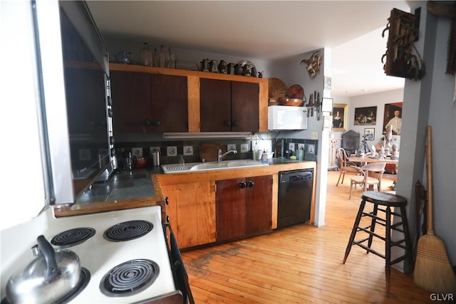 kitchen with stainless steel stove, black dishwasher, light wood-type flooring, and sink