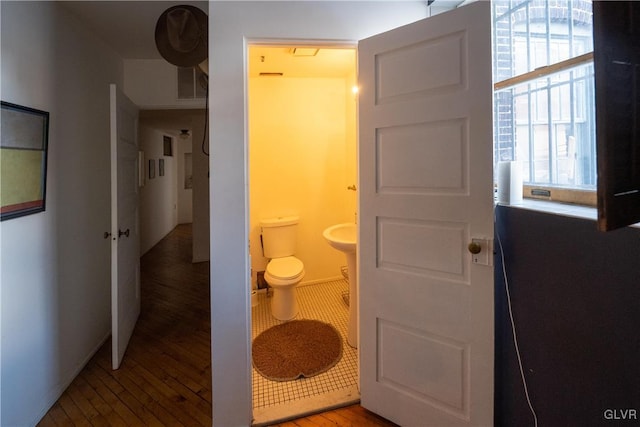 bathroom with toilet and wood finished floors