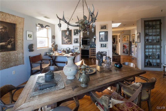dining area with visible vents and hardwood / wood-style floors