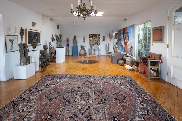 interior space with a chandelier, wood-type flooring, and lofted ceiling