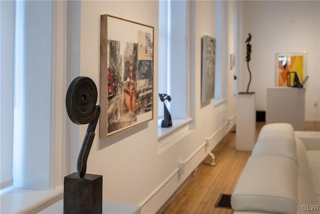 hallway with light wood-style flooring and visible vents