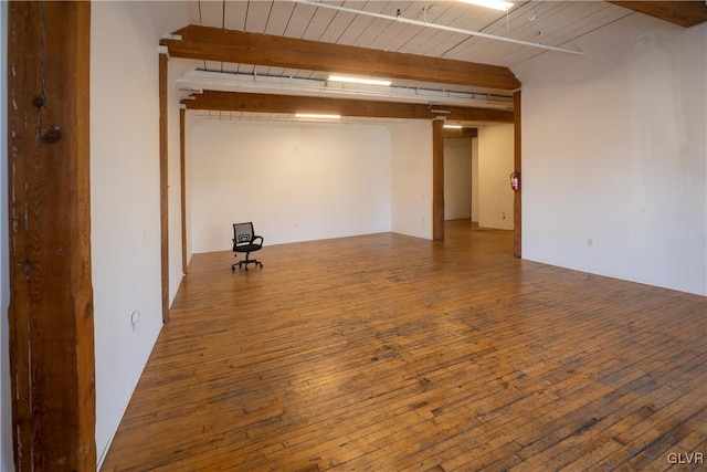 spare room featuring wood-type flooring, wooden ceiling, and beam ceiling