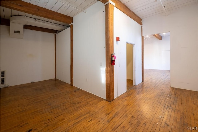 interior space featuring beamed ceiling, wooden ceiling, wood-type flooring, and visible vents