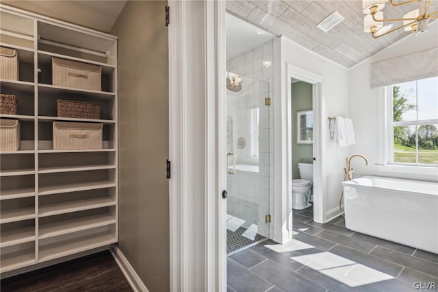 bathroom with tile patterned flooring, a notable chandelier, toilet, independent shower and bath, and vaulted ceiling