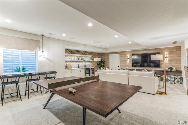 game room with light colored carpet, plenty of natural light, and a tray ceiling