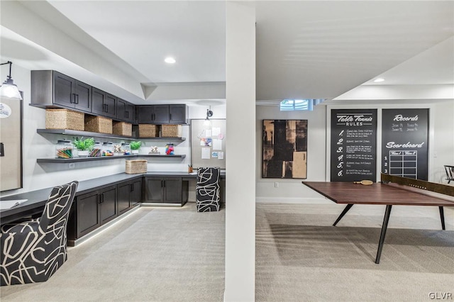 kitchen featuring pendant lighting and light carpet