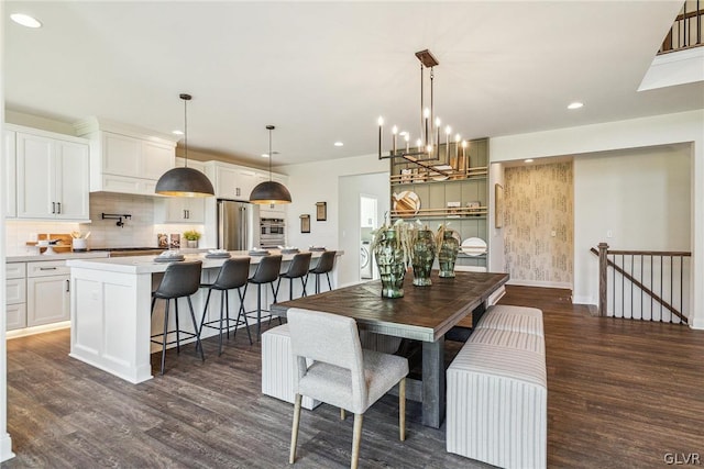 dining area with a chandelier and dark wood-type flooring