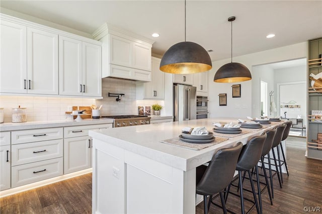 kitchen with a center island, decorative backsplash, and stainless steel appliances