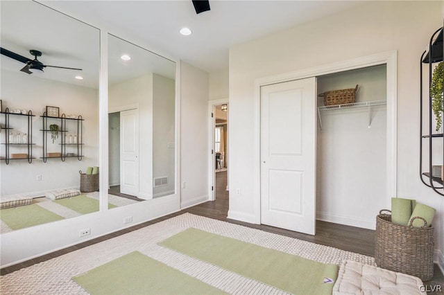 interior space with wood-type flooring and ceiling fan