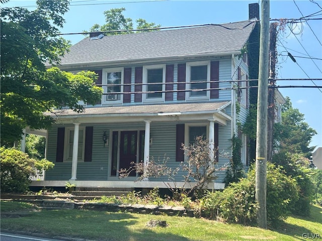 view of front of property featuring a porch and a balcony