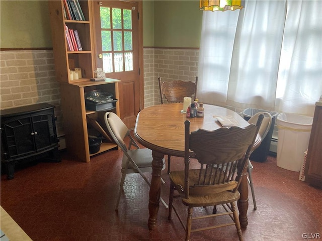 carpeted dining space with baseboard heating