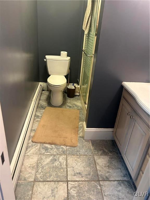 bathroom with tile patterned floors, vanity, toilet, and a baseboard radiator