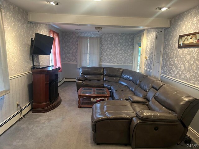 carpeted living room with beam ceiling and a baseboard heating unit