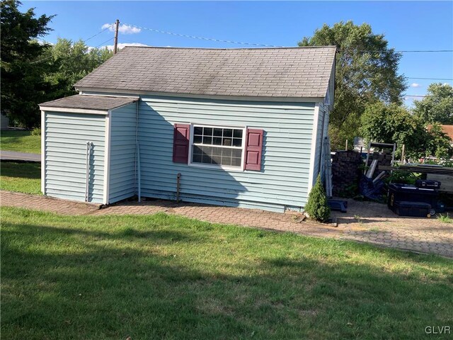 view of outbuilding featuring a lawn