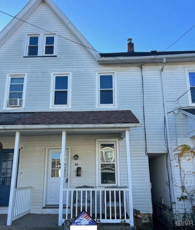 view of front of house with a porch and cooling unit