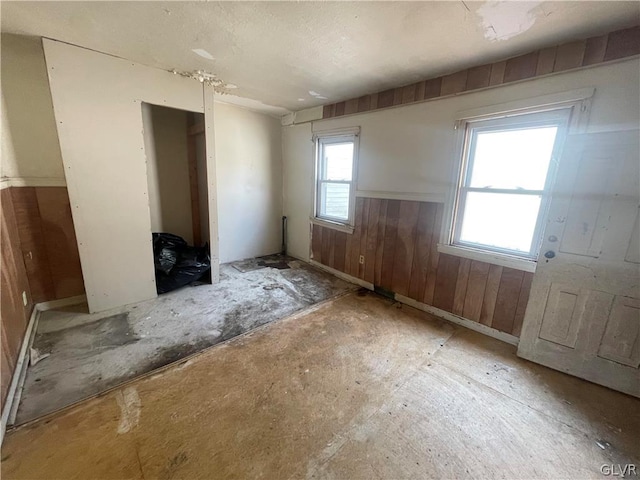 unfurnished bedroom with wood walls