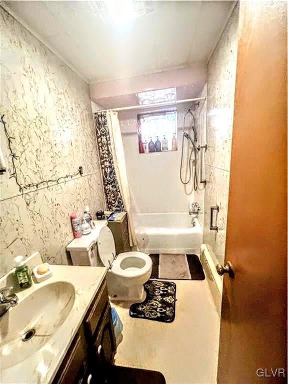 full bathroom featuring vanity, shower / bath combo, and toilet