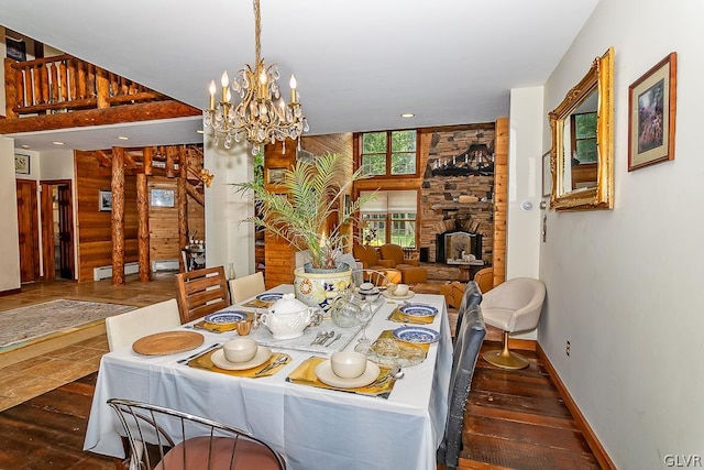 dining room featuring a fireplace, dark wood-type flooring, and a chandelier