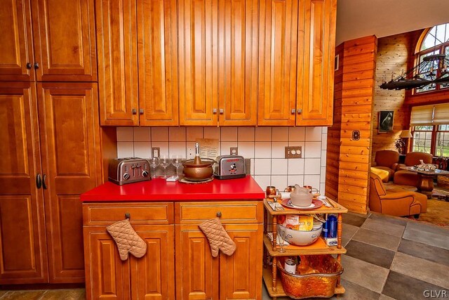 kitchen with wooden walls and tasteful backsplash