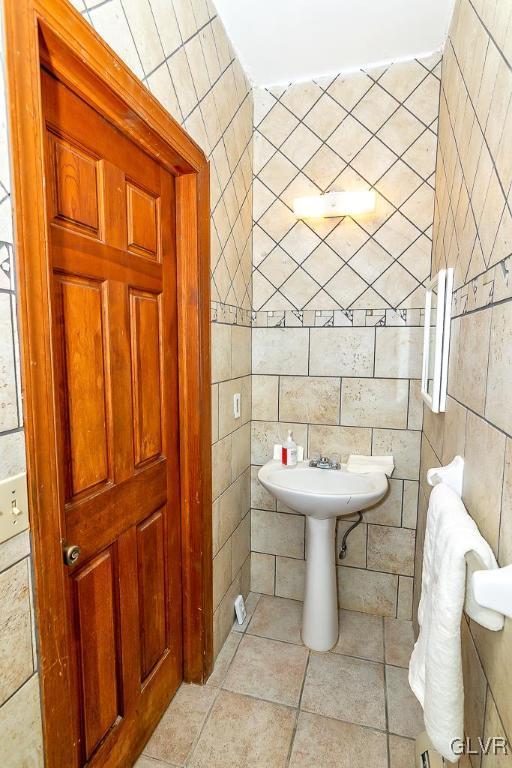 bathroom featuring tile patterned floors and tile walls