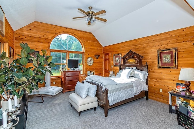 bedroom featuring carpet, lofted ceiling, wood walls, and ceiling fan