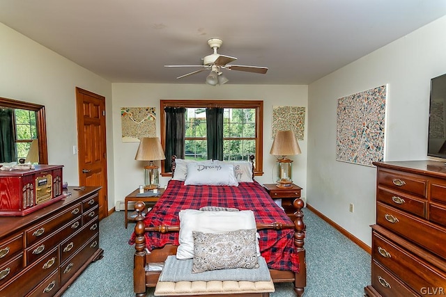 carpeted bedroom featuring a baseboard heating unit and ceiling fan