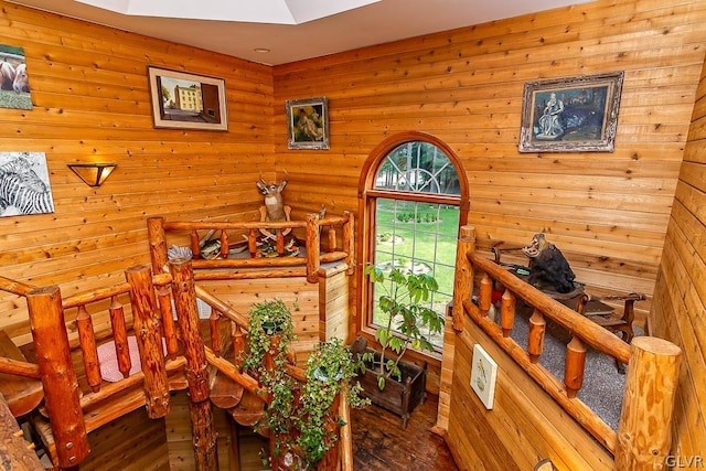 bedroom with wood-type flooring and wood walls