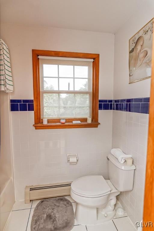 bathroom with a baseboard radiator, tile walls, tile patterned flooring, and toilet