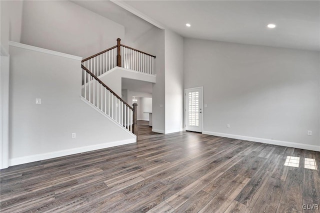 unfurnished living room featuring high vaulted ceiling, wood-type flooring, and ornamental molding