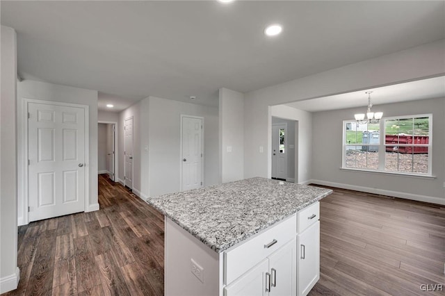 kitchen featuring dark hardwood / wood-style flooring, white cabinets, and a kitchen island