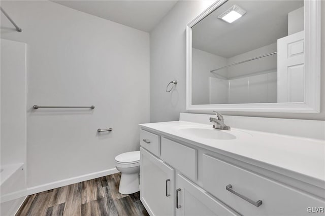 full bathroom with vanity, hardwood / wood-style floors, tub / shower combination, and toilet