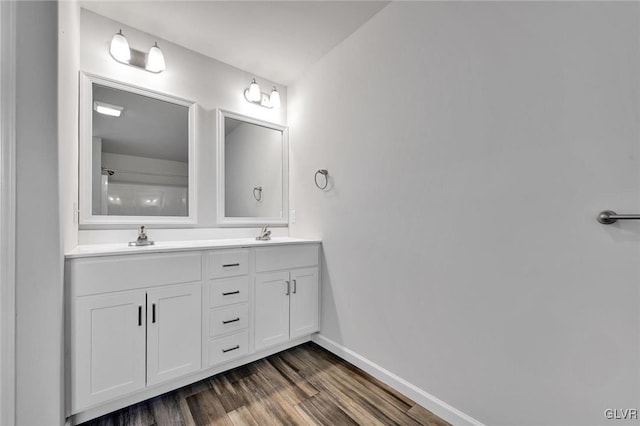 bathroom featuring hardwood / wood-style floors and double sink vanity