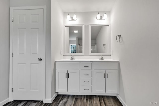 bathroom with hardwood / wood-style floors and double vanity