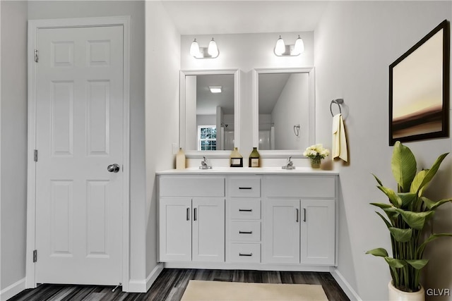 bathroom featuring dual vanity and hardwood / wood-style flooring