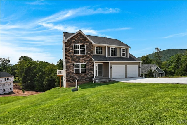 view of front facade with a garage and a front lawn