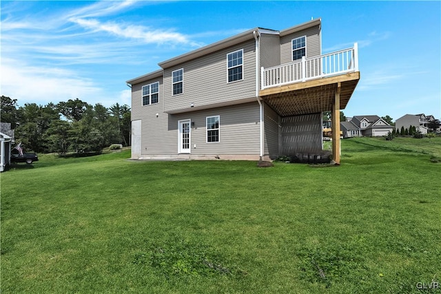 rear view of property with a yard and a balcony