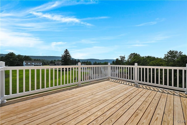 wooden deck featuring a lawn