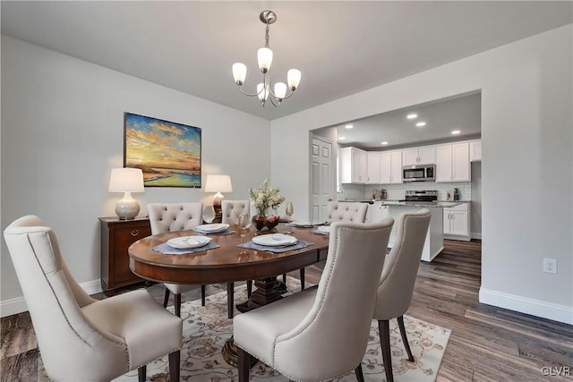 dining area featuring an inviting chandelier and dark hardwood / wood-style floors