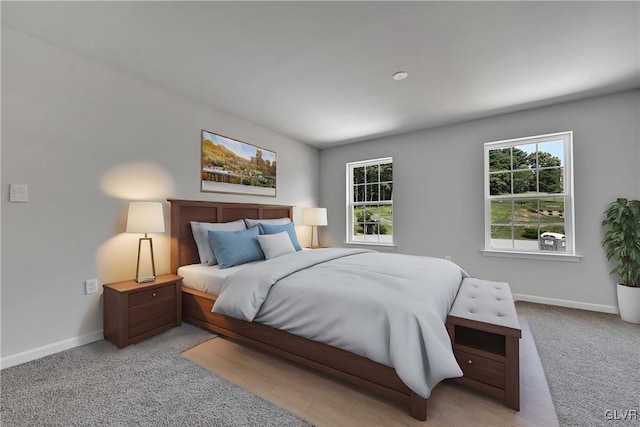 bedroom featuring light hardwood / wood-style floors and multiple windows