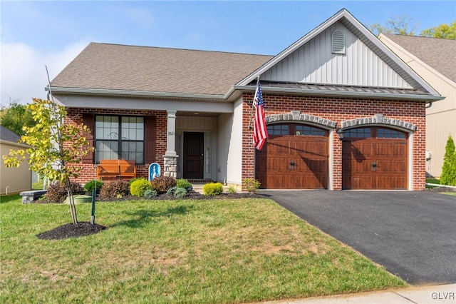 view of front of house with a garage and a front yard