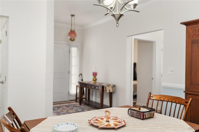 dining space featuring a chandelier and crown molding