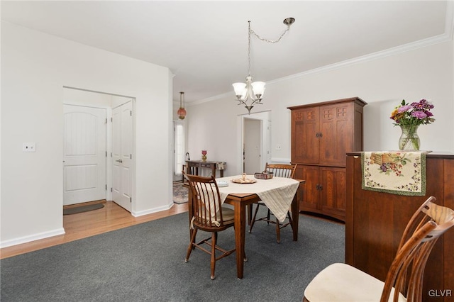 dining area featuring hardwood / wood-style flooring, a chandelier, and crown molding