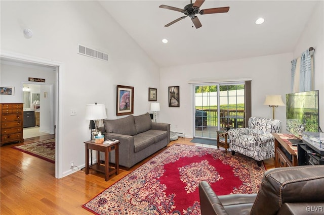 living room with high vaulted ceiling, ceiling fan, wood-type flooring, and a baseboard radiator