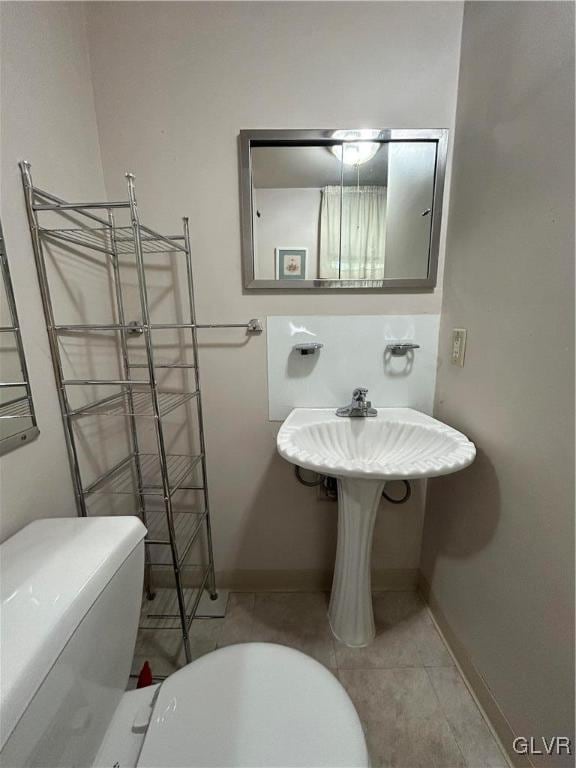 bathroom with toilet and tile patterned floors