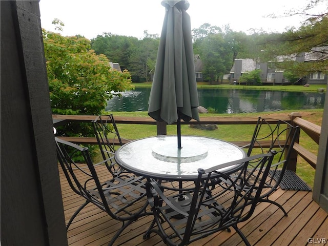 deck with a yard and a water view