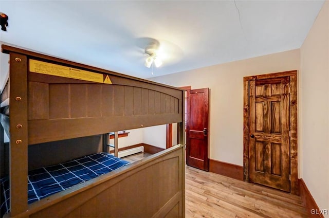 unfurnished bedroom featuring light wood-type flooring and ceiling fan