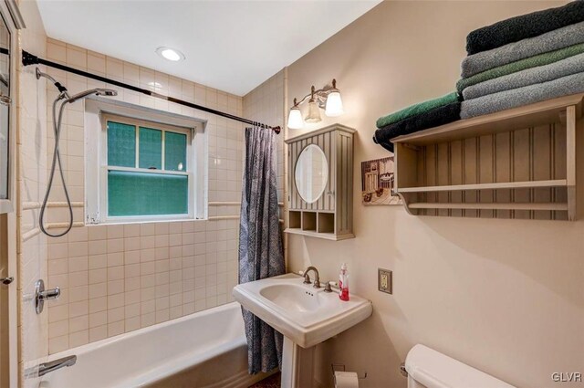 bathroom with shower / bath combo and toilet