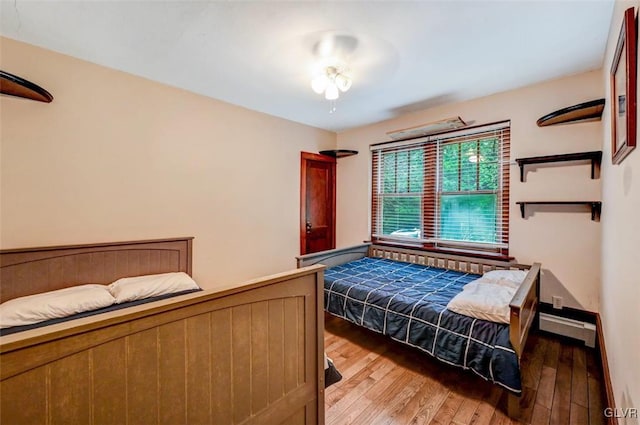 bedroom with hardwood / wood-style flooring