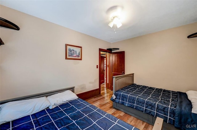 bedroom with ceiling fan and hardwood / wood-style floors